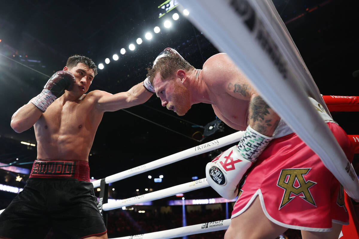 Dmitry Bivol, left, throws a punch against Saul “Canelo” Alvarez in the 10th roun ...