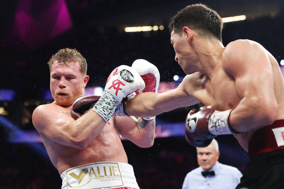 Saul “Canelo” Alvarez, left, battles for Dmitry Bivol in the sixth round of the W ...