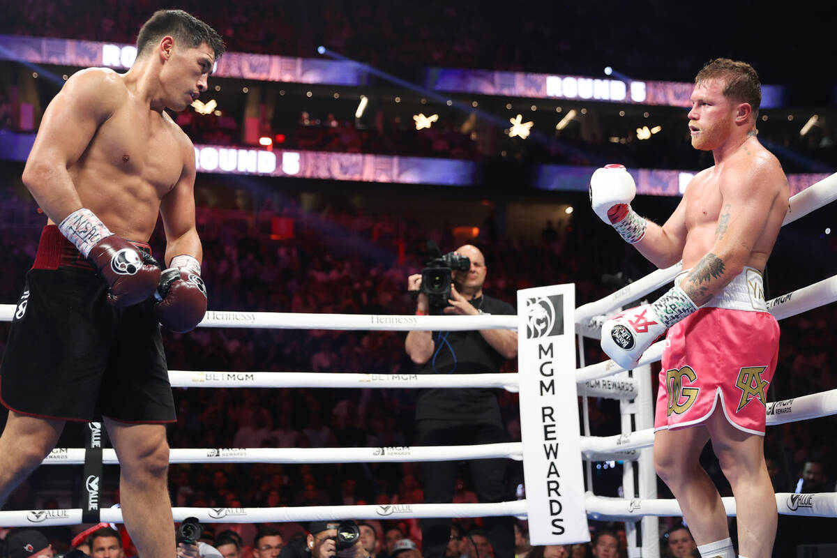 Saul “Canelo” Alvarez, right, gestures for Dmitry Bivol to come forward in the fi ...