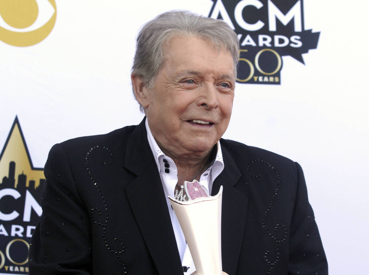 FILE - Mickey Gilley poses with the Triple Crown Award on the red carpet at the 50th annual Aca ...
