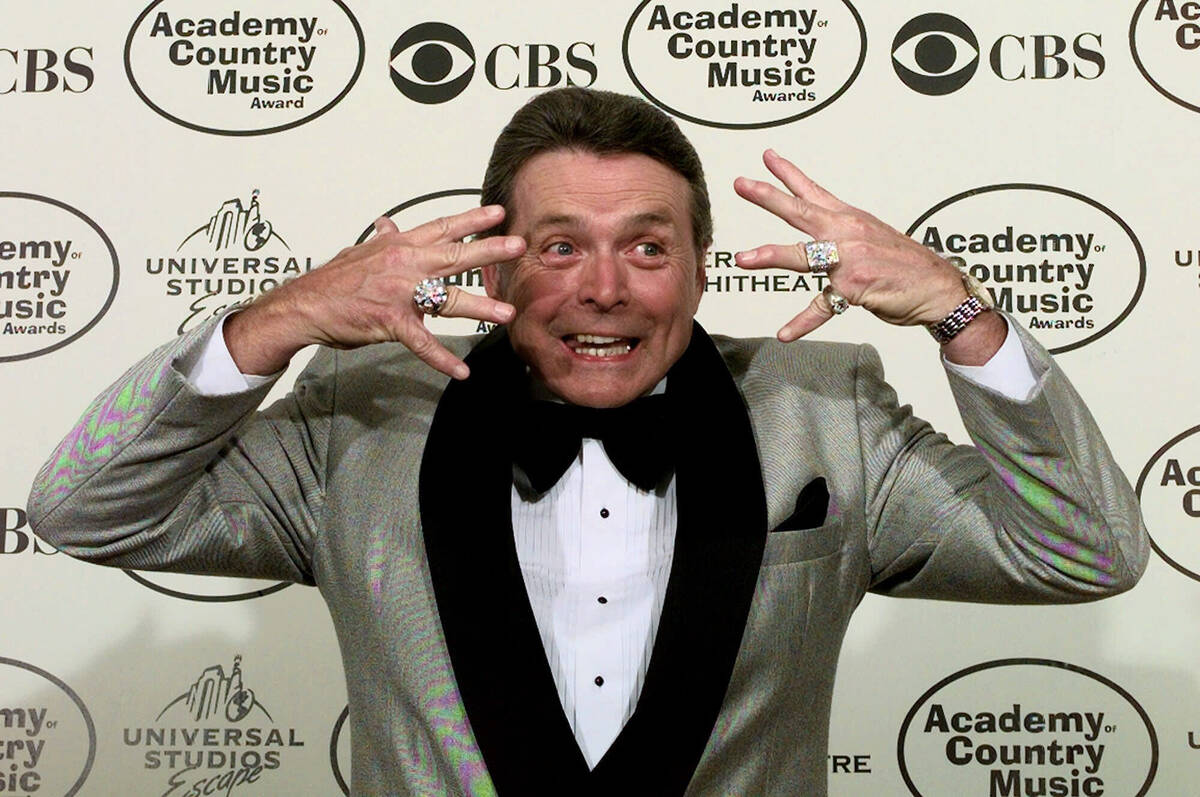 FILE - Presenter Mickey Gilley shows off his diamond rings to the media during the 34th Annual ...