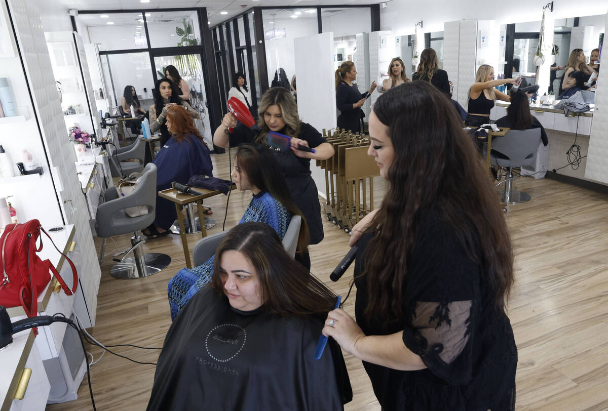 Capelli Salon hairdresser Jessica Bonsignore, right, dries abuse survivor Tania Mac Davidճ hai ...