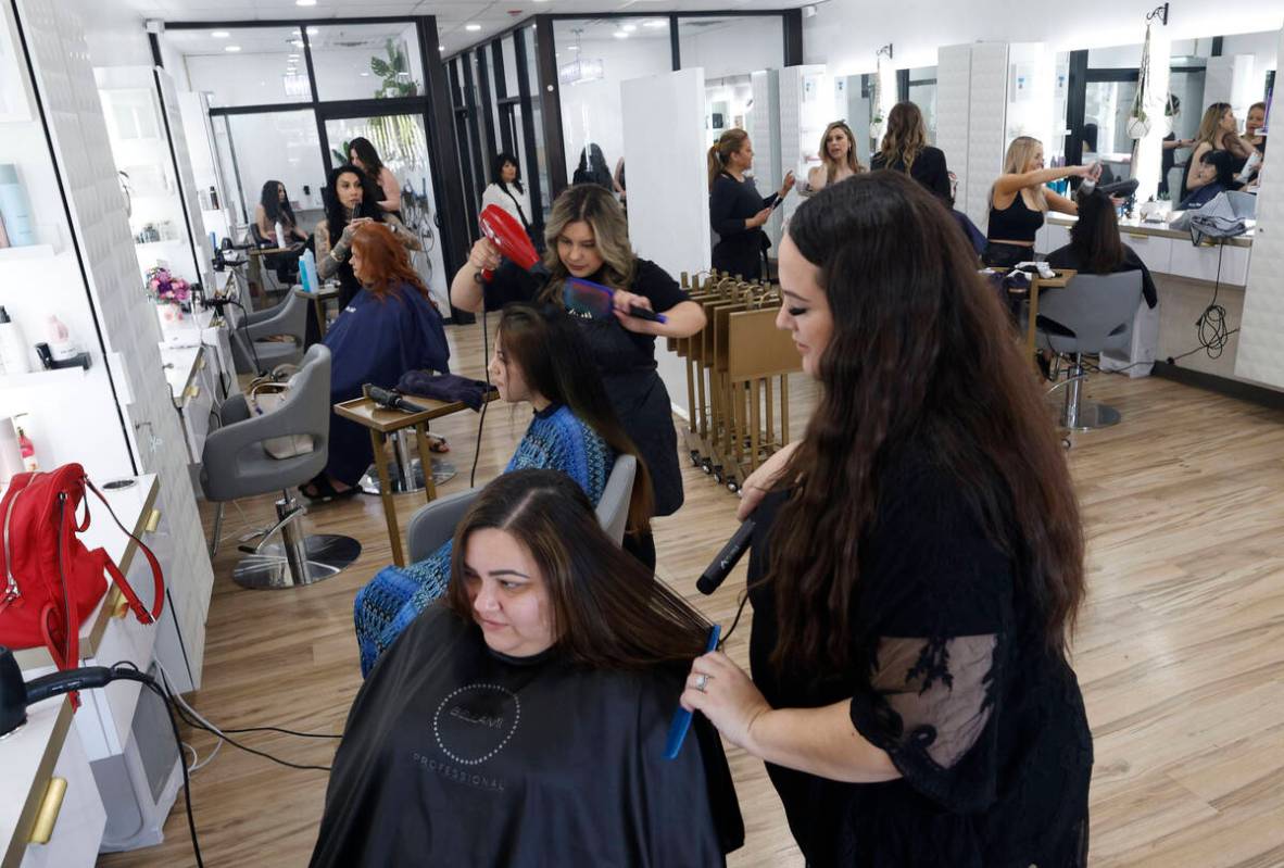 Capelli Salon hairdresser Jessica Bonsignore, right, dries the hair of Tania MacDavid, a surviv ...
