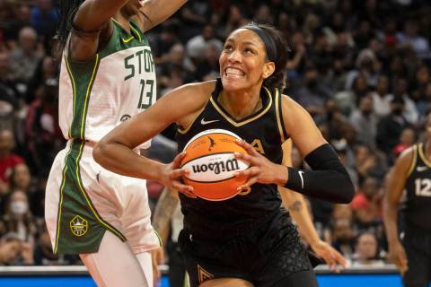 Aces forward A'ja Wilson (22) drives past Seattle Storm center Ezi Magbegor (13) in the first h ...