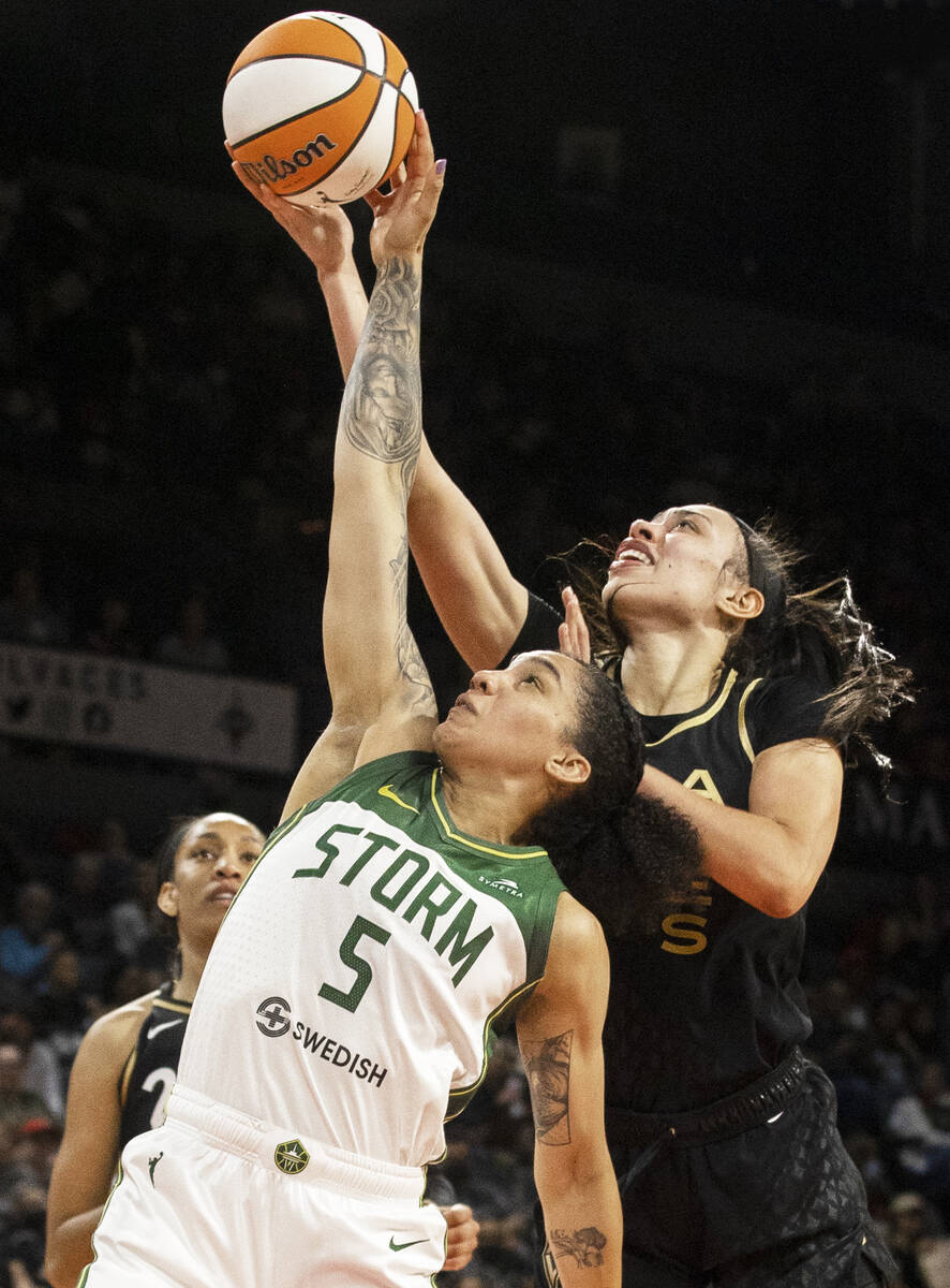 Aces forward Dearica Hamby (5) fights for a rebound with Seattle Storm’s Gabby Williams ...
