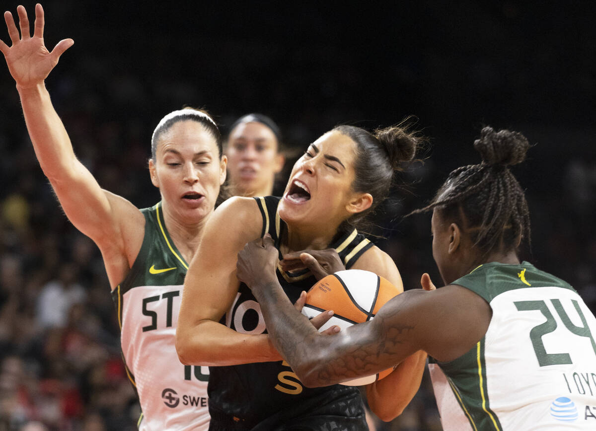 Aces guard Kelsey Plum (10) is fouled by Seattle Storm guard Jewell Loyd (24) and Seattle Storm ...