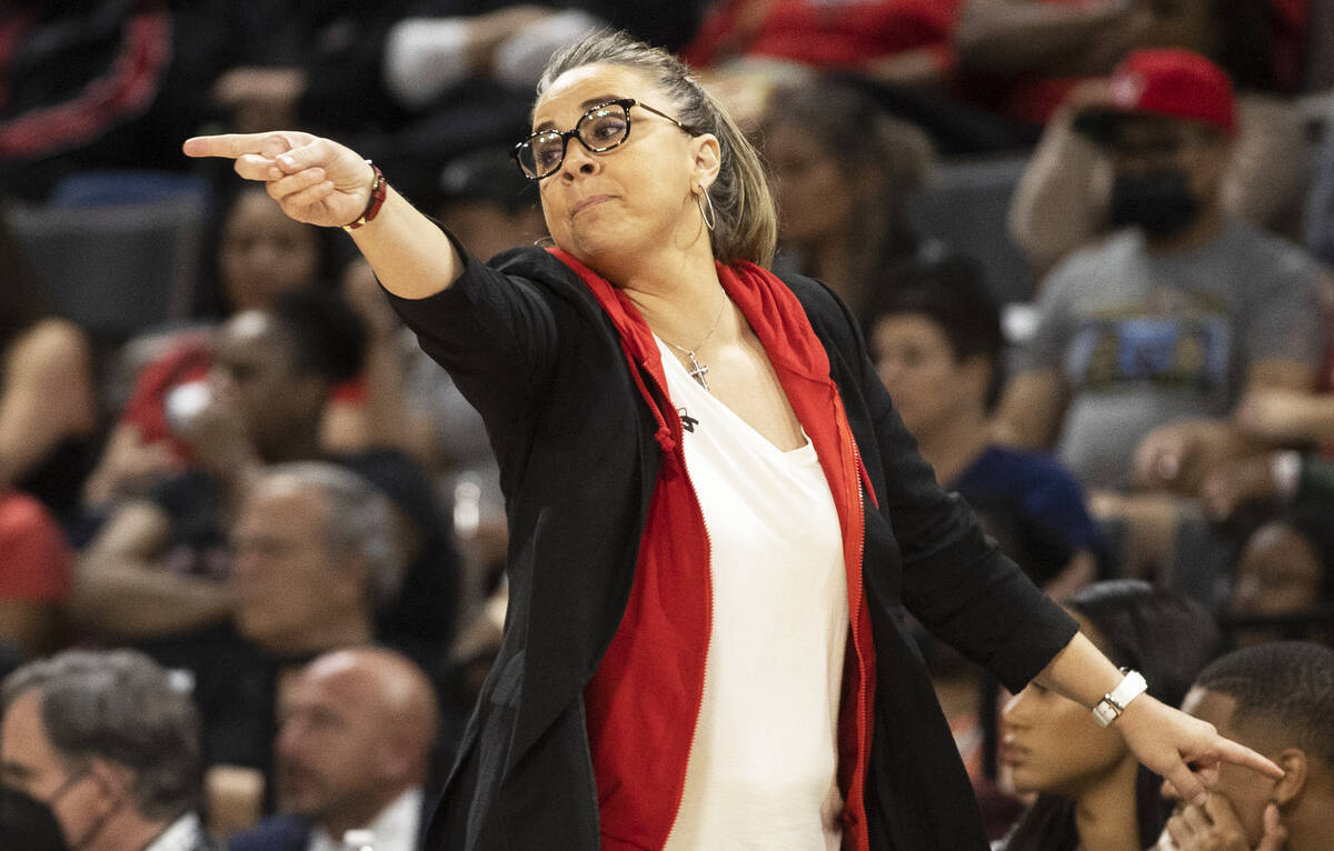 Aces head coach Becky Hammon coaches up her team in the second half of a WNBA basketball game a ...