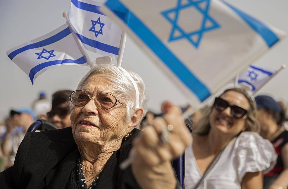 Holocaust survivor Lucy Jacobs, 94, waves an Israeli flag during a celebration of Israel’s in ...