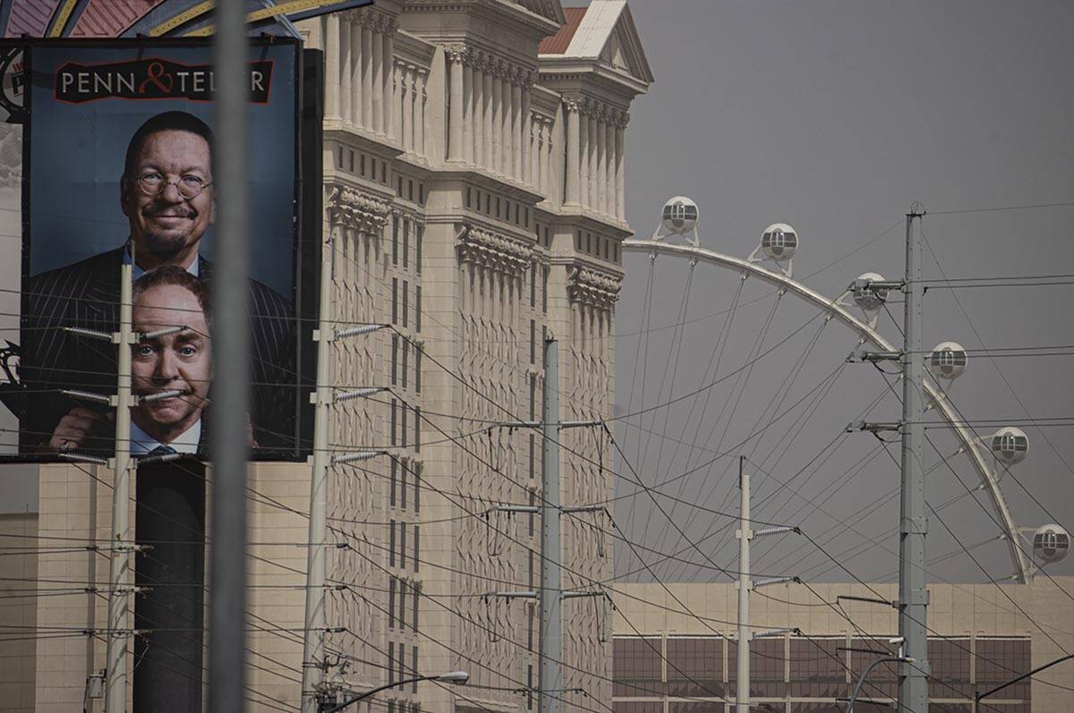 The High Roller is seen to the right, past Caesars Palace, as winds bring in a dust storm on Su ...
