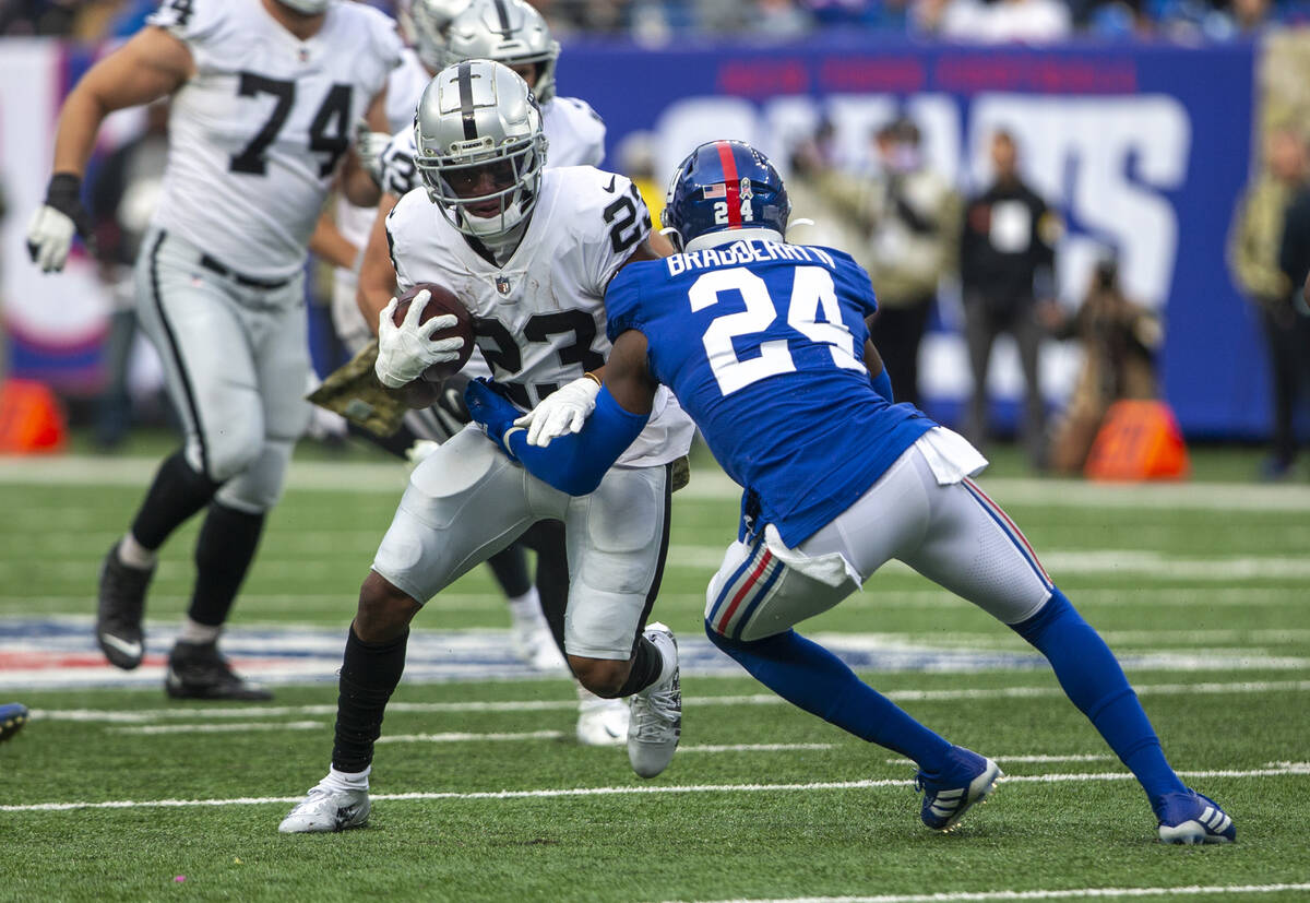 Las Vegas Raiders running back Kenyan Drake (23) looks for room to run against New York Giants ...