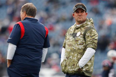 New England Patriots offensive coordinator Josh McDaniels, right, with head coach Bill Belichic ...