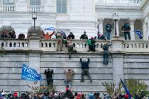 FILE - Supporters of President Donald Trump climb the west wall of the the U.S. Capitol during ...