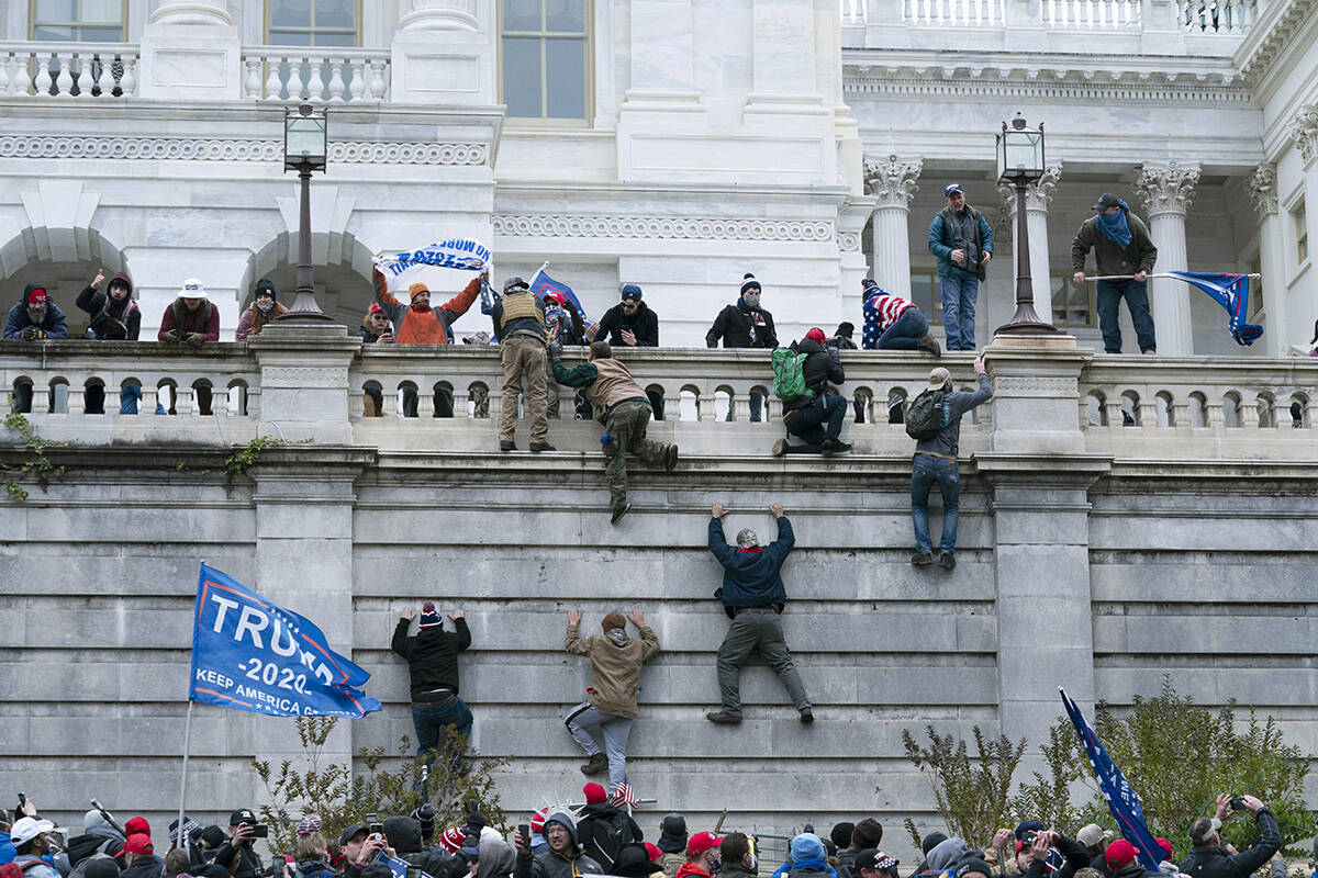 FILE - Supporters of President Donald Trump climb the west wall of the the U.S. Capitol during ...