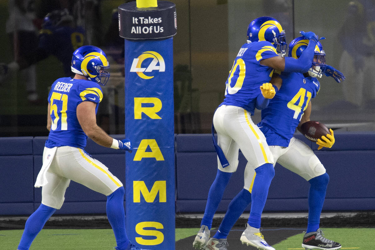 Los Angeles Rams linebacker Kenny Young (41), right, celebrates his touchdown on an interceptio ...