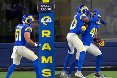 Los Angeles Rams linebacker Kenny Young (41), right, celebrates his touchdown on an interceptio ...