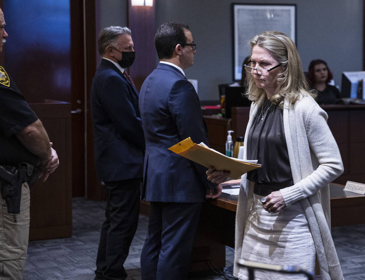 Avis Winters, the mother of attorney Susan Winters, walks past Gregory "Brent" Dennis, second l ...