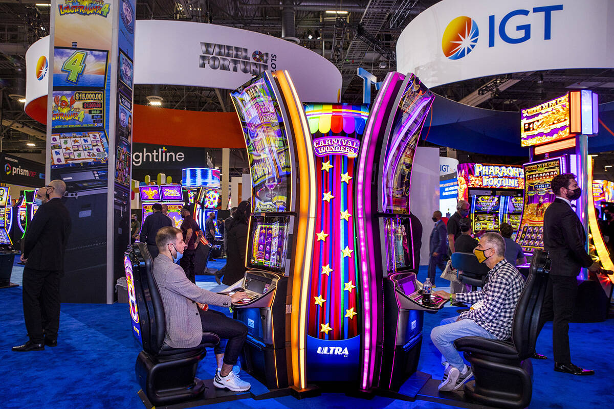 Attendees play the Carnival of Wonders machines in the IGT display space during day 2 of the Gl ...