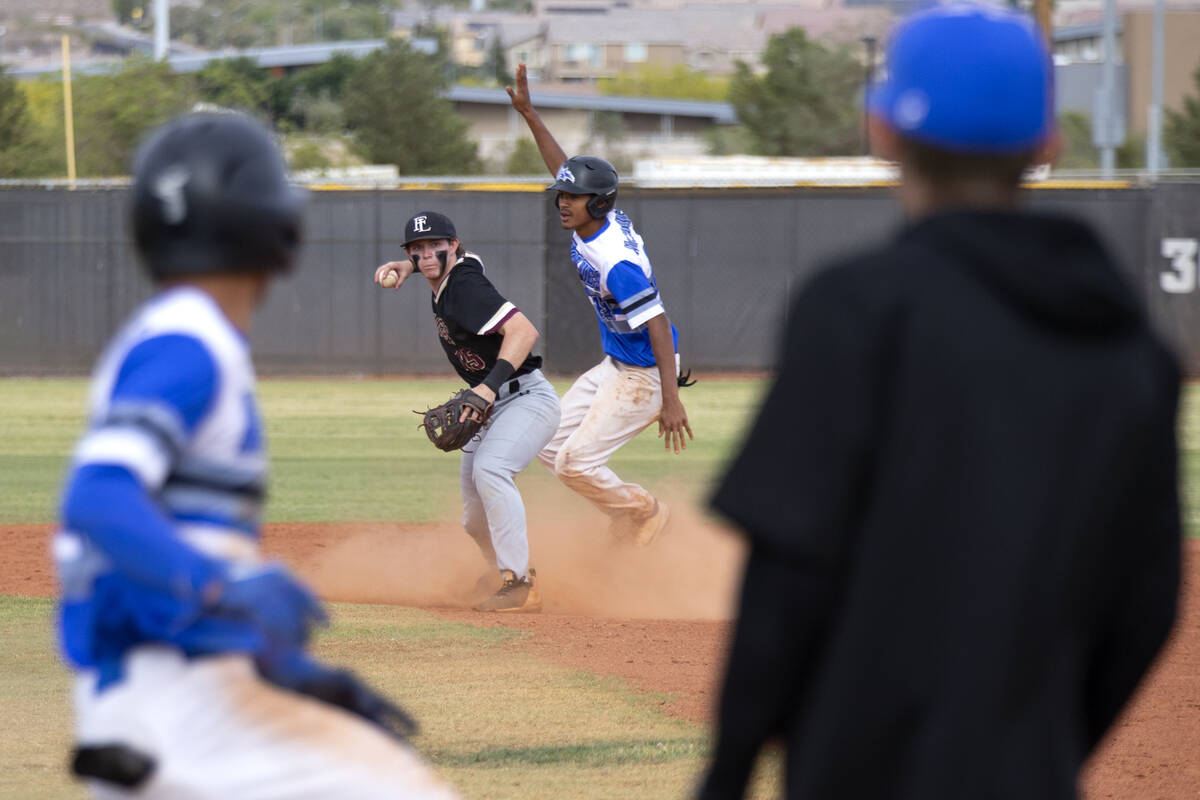 Faith Lutheran second baseman George Holt (15) attempts a double play at first base after makin ...