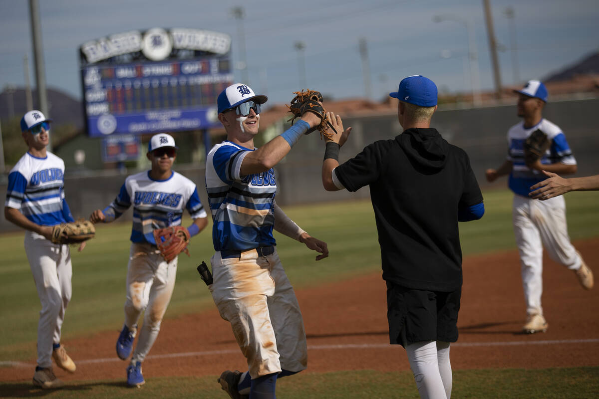 Basic outfielders including Mason Neville, center, run to the dugout after making a catch that ...