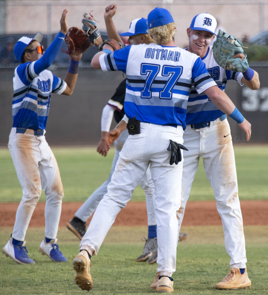 Basic’s Chase Ditmar (77) and Cooper Sheff (22) embrace after winning a Class 5A Souther ...