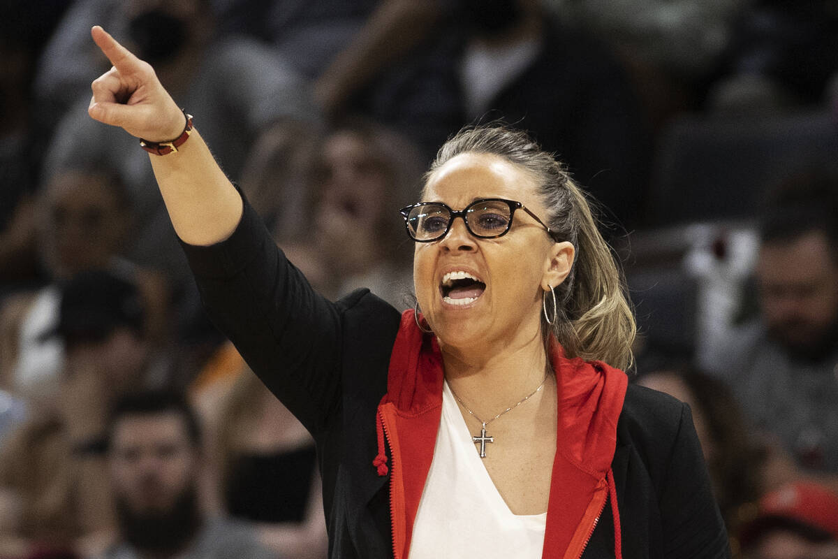 Aces head coach Becky Hammon coaches up her team in the second half of a WNBA basketball game a ...