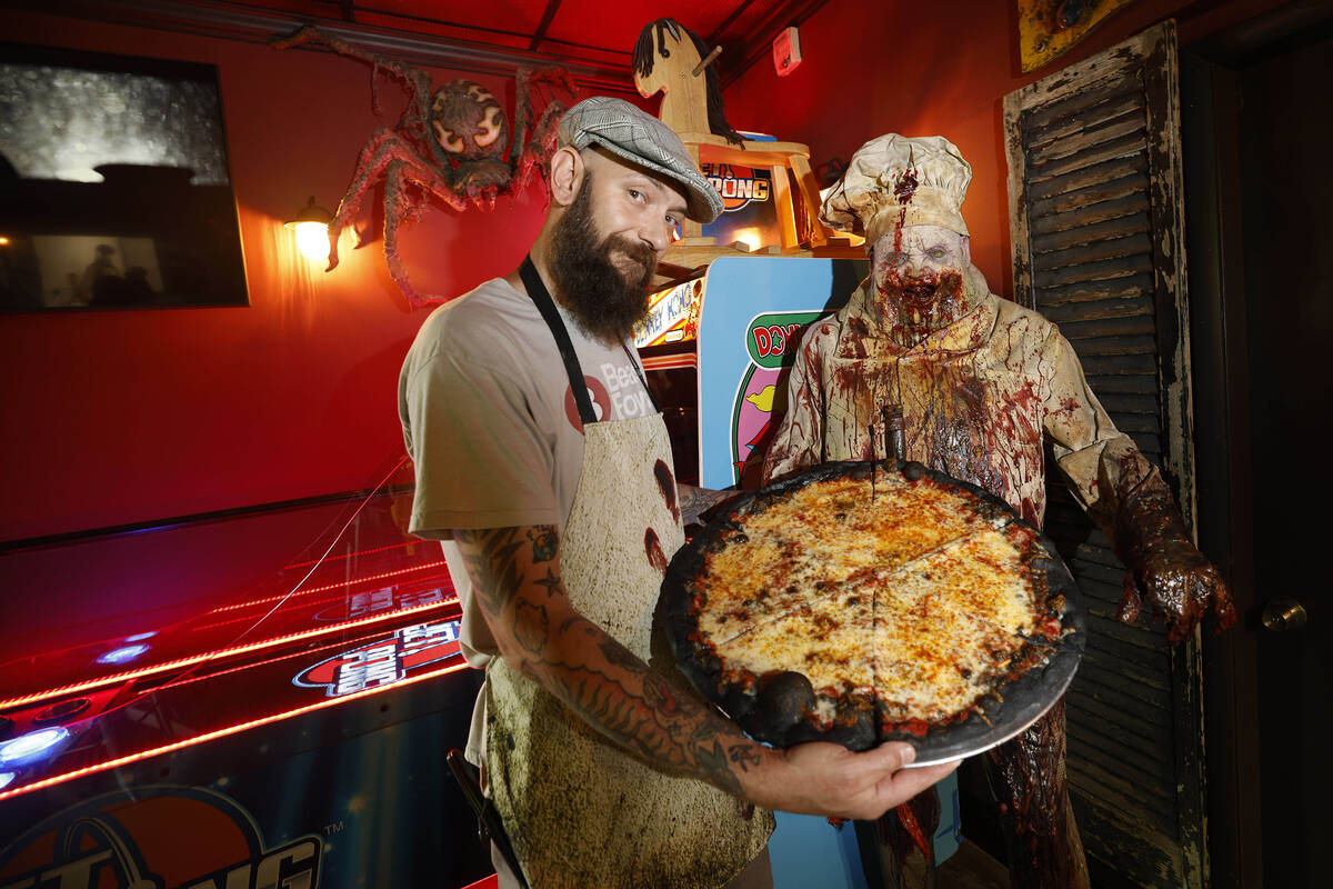 Sliced Pizza co-owner Cash Sakoulas shows a Murder Pie at his shop, Sunday, May 8, 2022, in Las ...