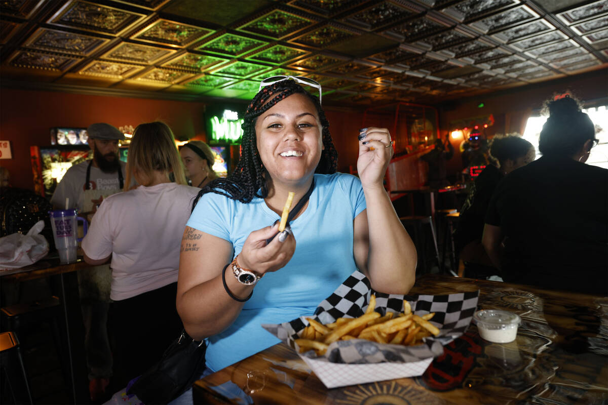 Customer Chandra Weekly of Las Vegas eats fries at Sliced Pizza, Sunday, May 8, 2022, in Las Ve ...