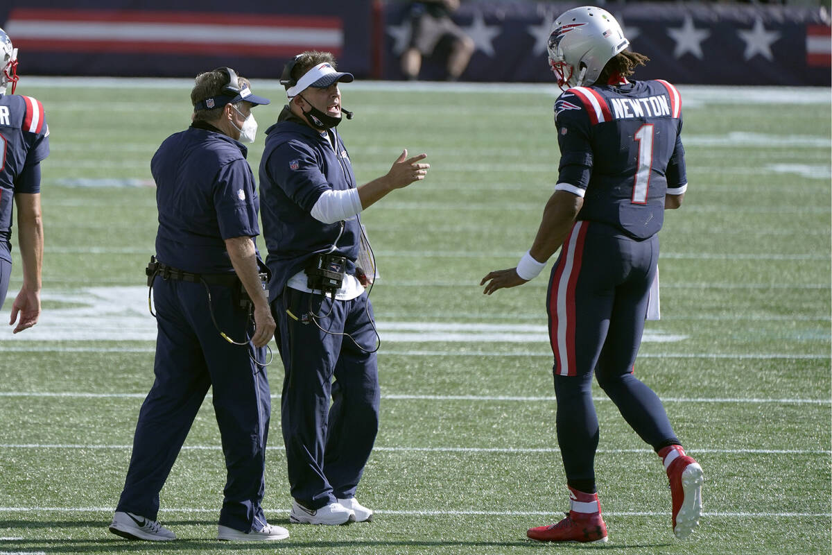 New England Patriots offensive coordinator Josh McDaniels, center, speaks to quarterback Cam Ne ...