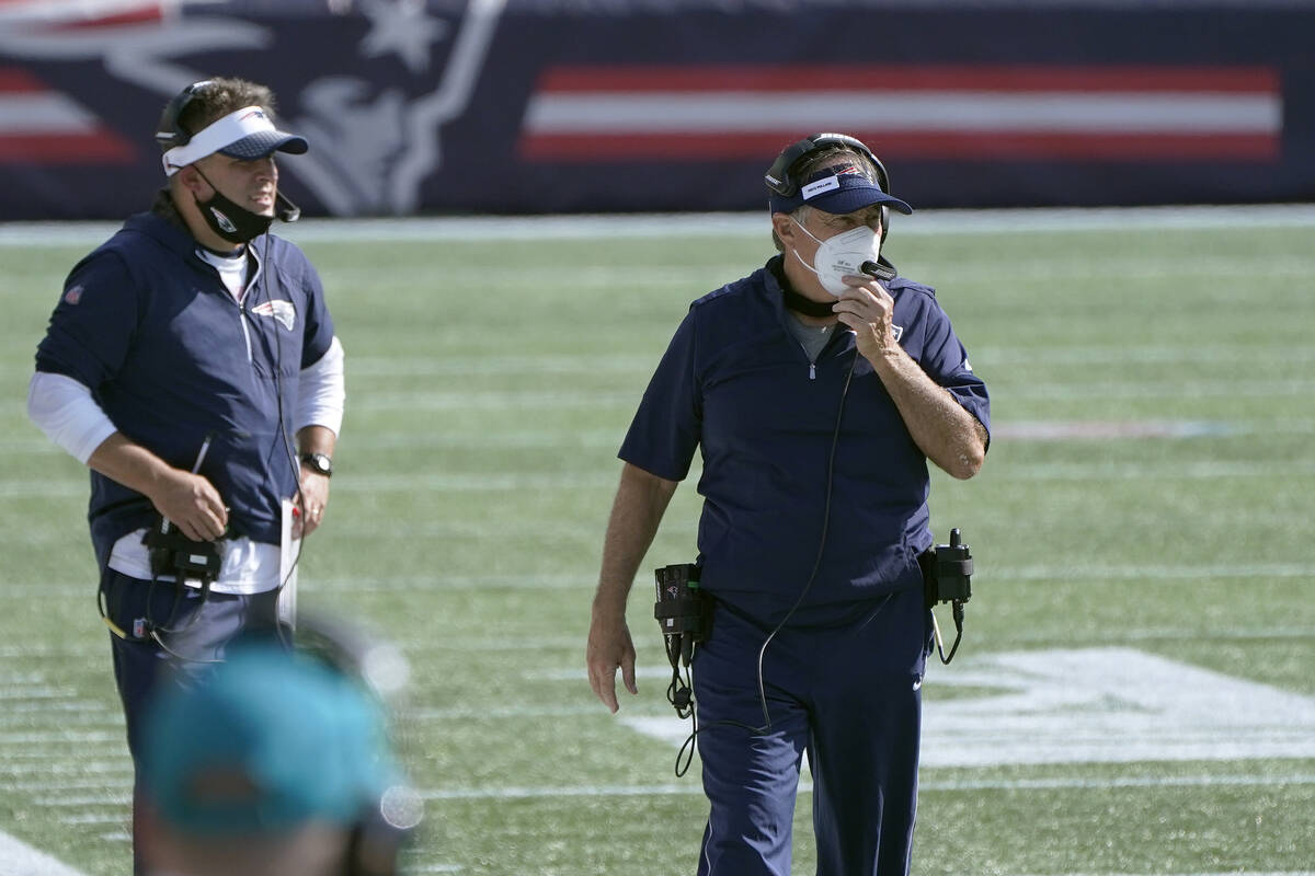 New England Patriots offensive coordinator Josh McDaniel, left, head coach Bill Belichick watch ...