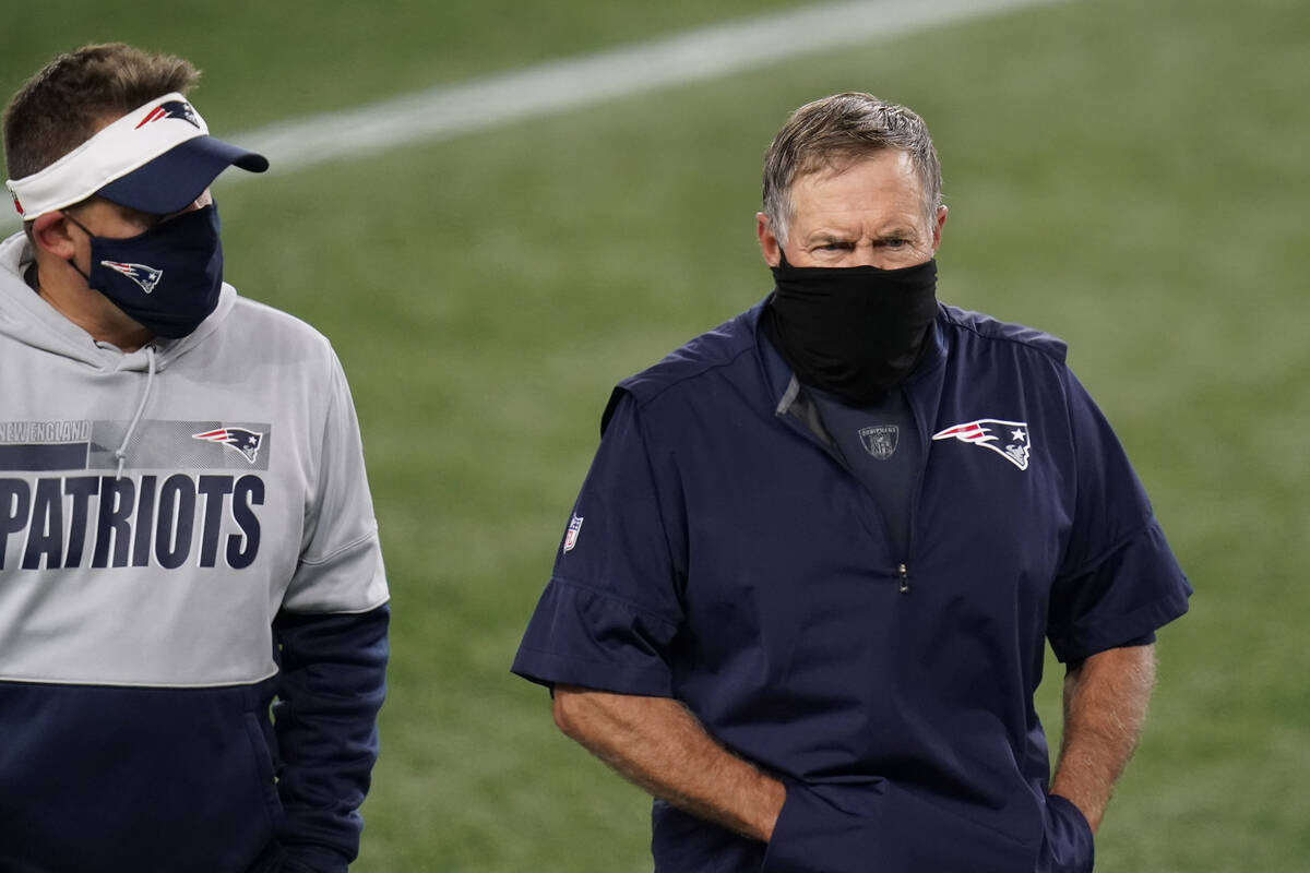 New England Patriots offensive coordinator Josh McDaniels and head coach Bill Belichick leave t ...