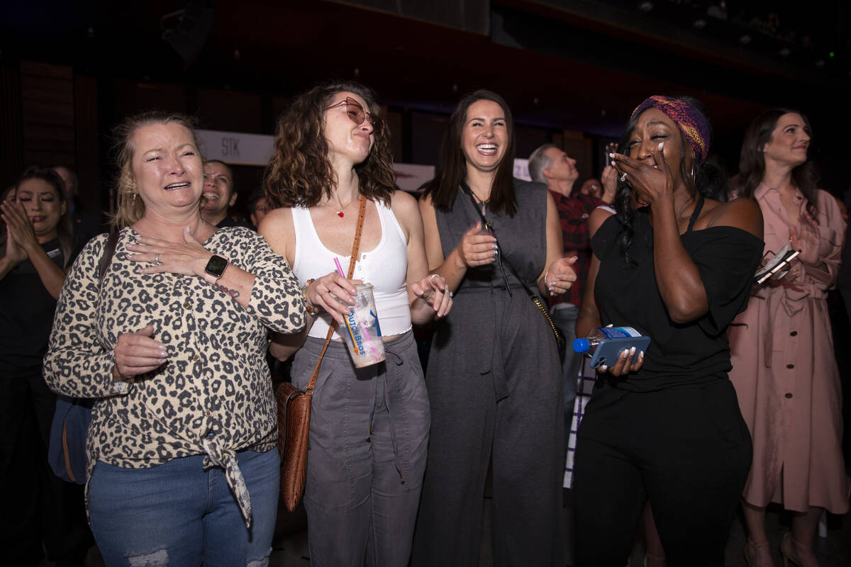 Cosmopolitan of Las Vegas employees celebrate after they were awarded a $5000 bonus during an e ...