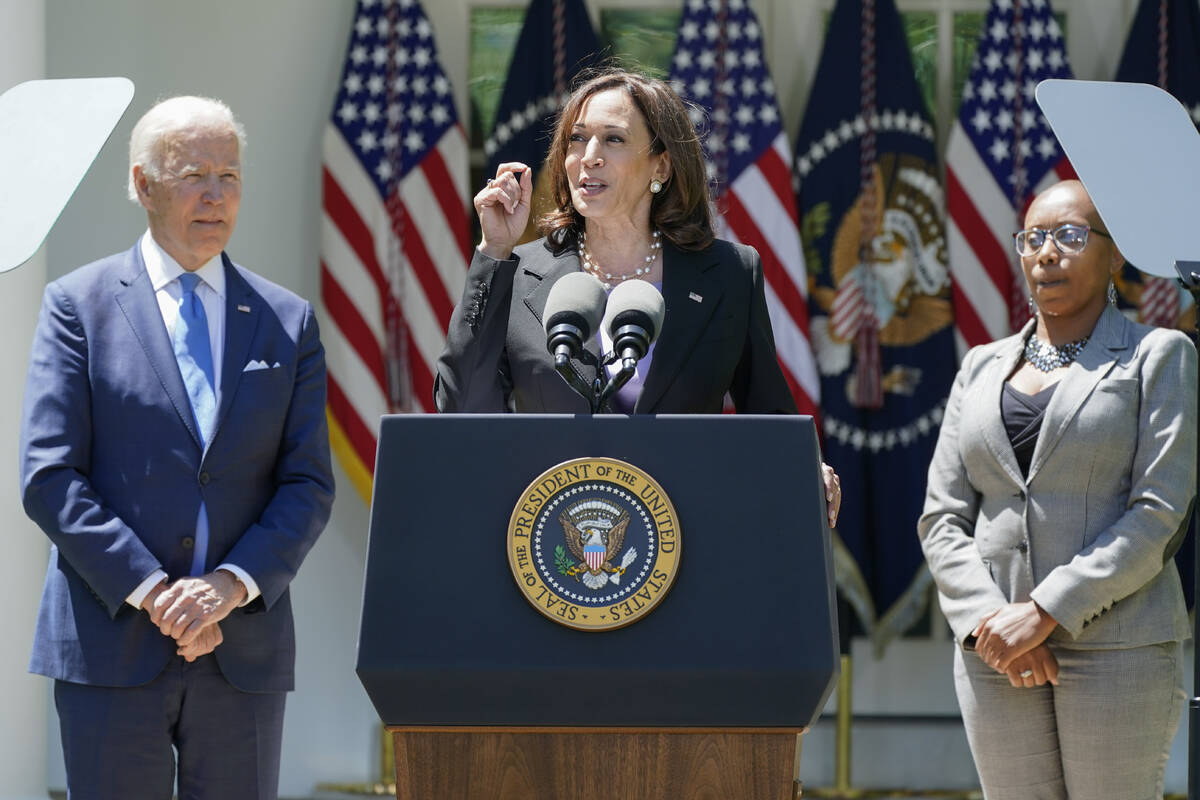 President Joe Biden listens as Vice President Kamala Harris speaks at an event on lowering the ...