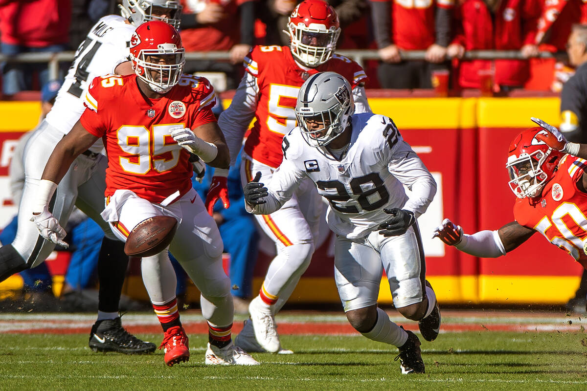 Raiders running back Josh Jacobs (28) loses the ball as Kansas City Chiefs defensive end Chris ...