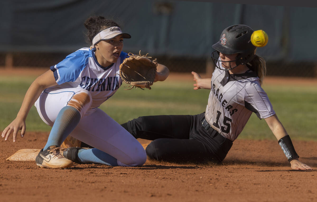 Faith Lutheran’s Savannah Moore (15) tries to slide in safely past Centennial’s K ...