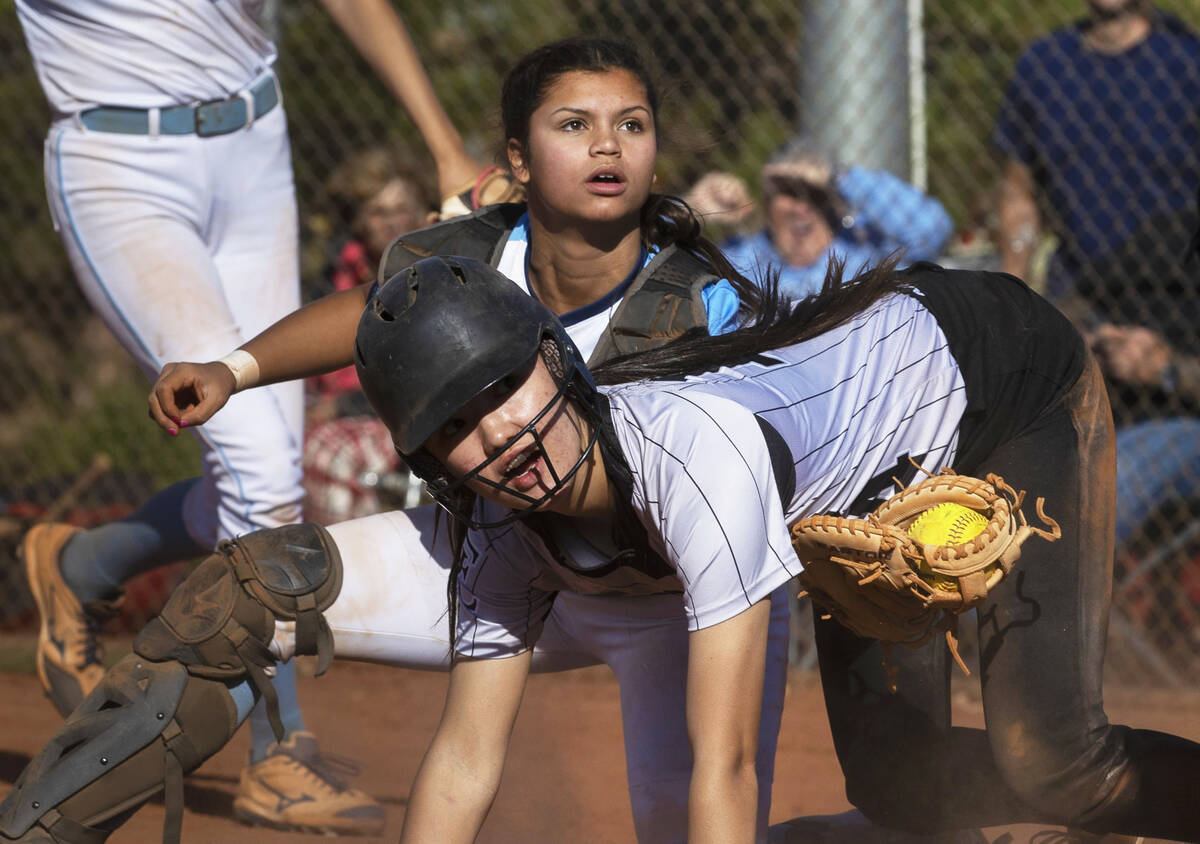 Centennial’s Amanda Campos-Colon (9) tags out Faith Lutheran’s Averi O (14) durin ...