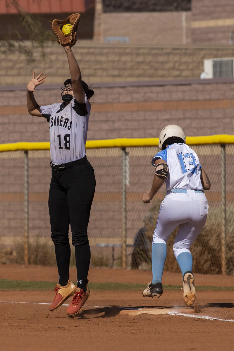 Faith Lutheran’s Ava Mariani (18) leaps to catch a high throw as Centennial’s Kea ...