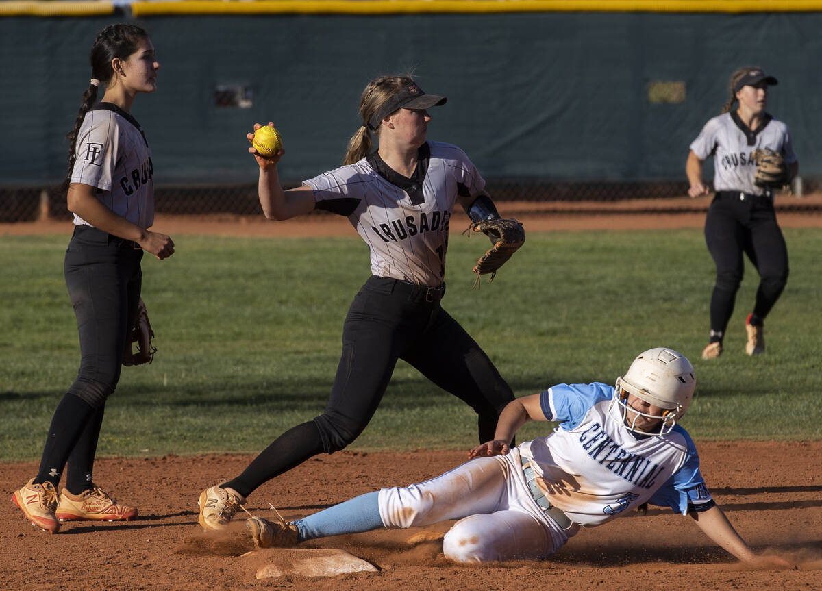 Faith Lutheran’s Savannah Moore (15) attempts to turn two over Centennial’s Ashle ...