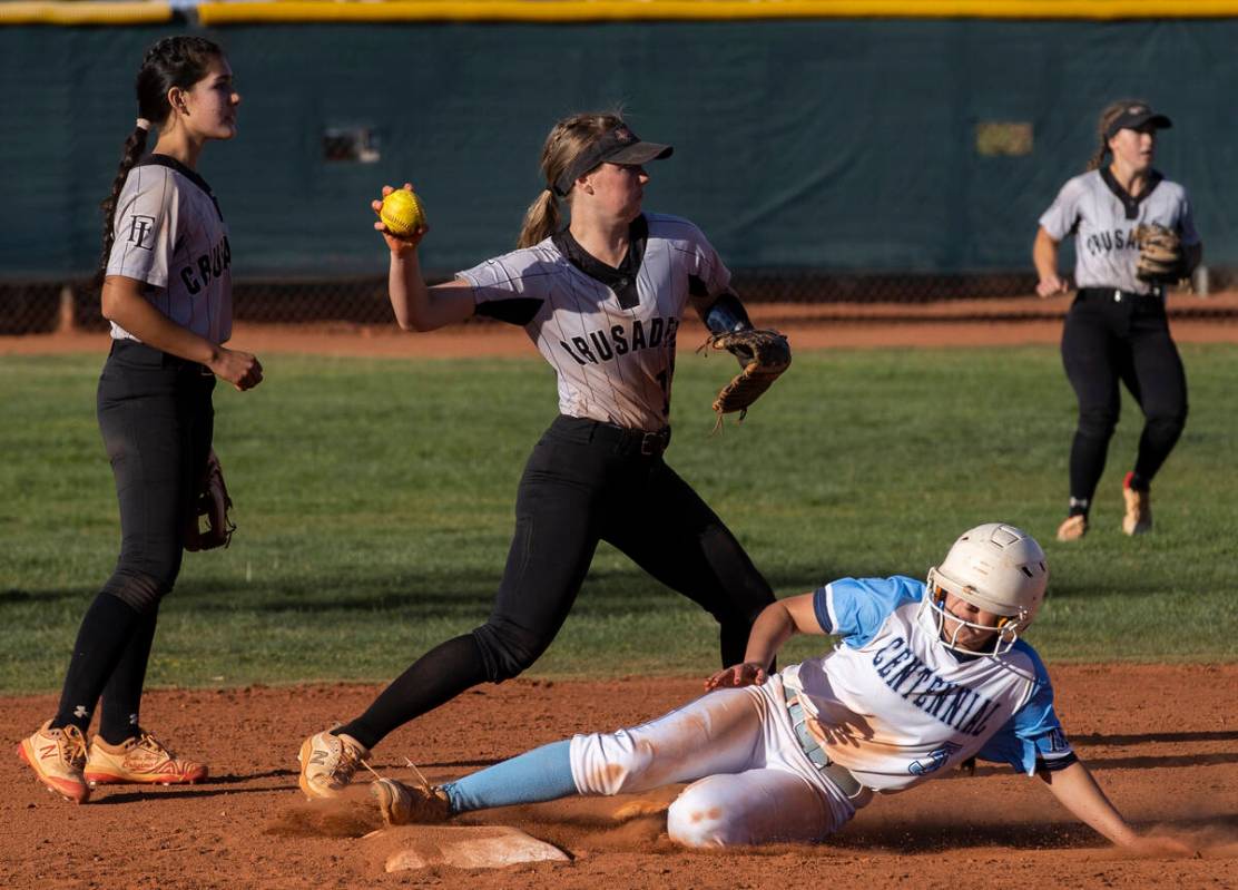 Faith Lutheran’s Savannah Moore (15) attempts to turn two over Centennial’s Ashle ...