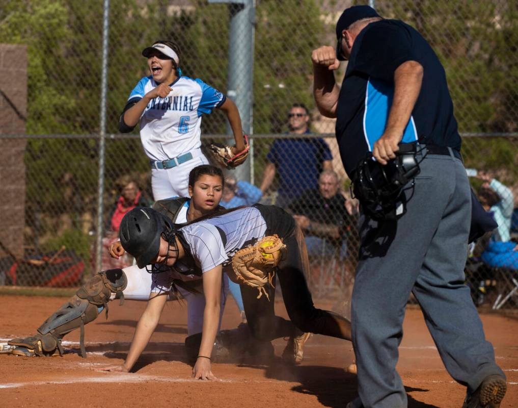 Centennial’s Amanda Campos-Colon (9) tags out Faith Lutheran’s Averi O (14) while ...