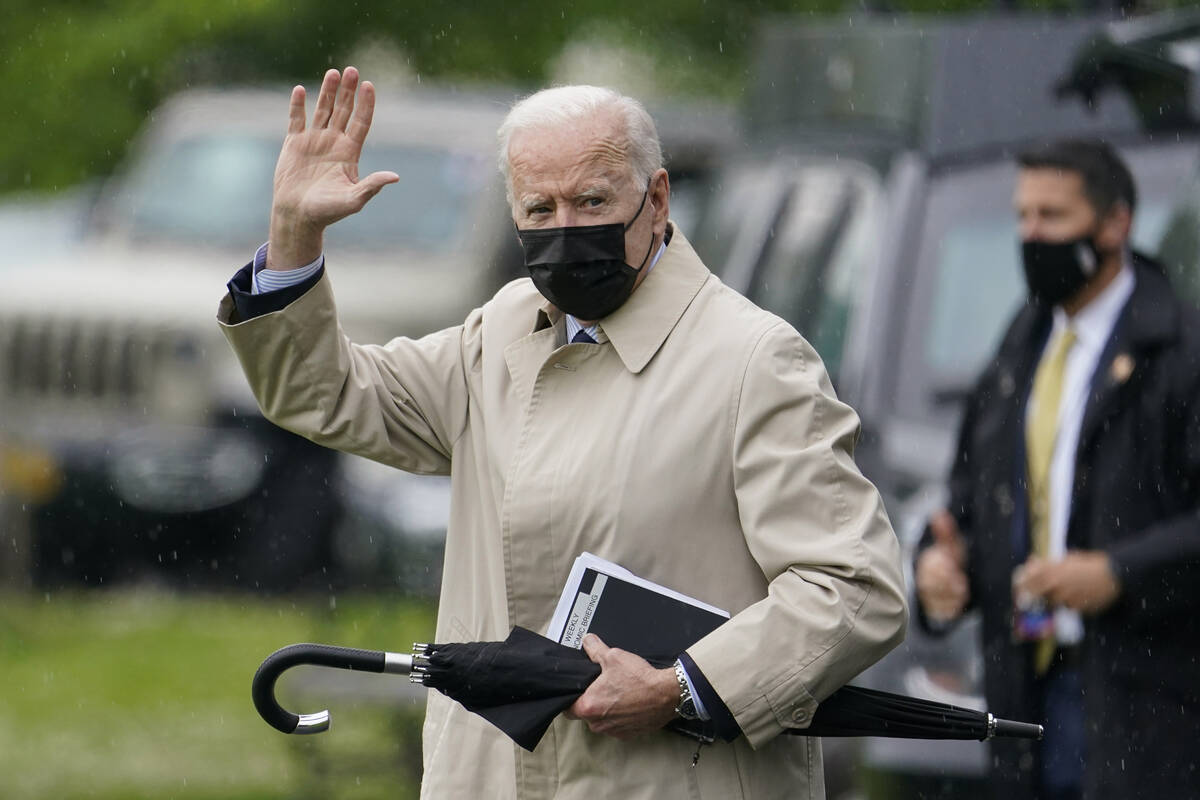 President Joe Biden waves as he walks to Marine One on the Ellipse near the White House, Friday ...