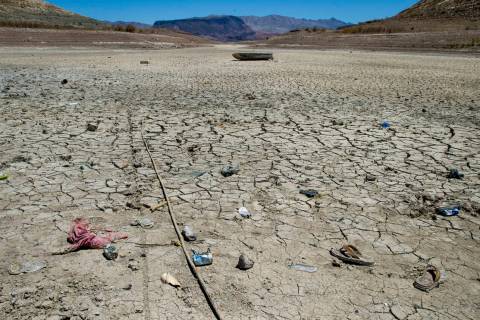 Old clothing and trash remains as the waterline continues to recede about the closed Boulder Ha ...