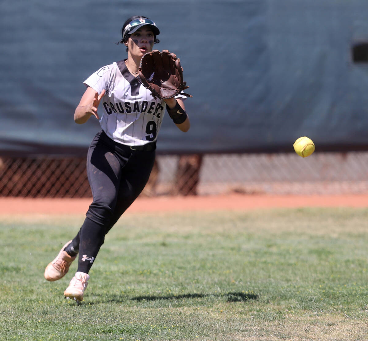 Faith Lutheran outfielder Sydney Schafer (9) fields a hit in the 2nd inning in a Class 5A South ...