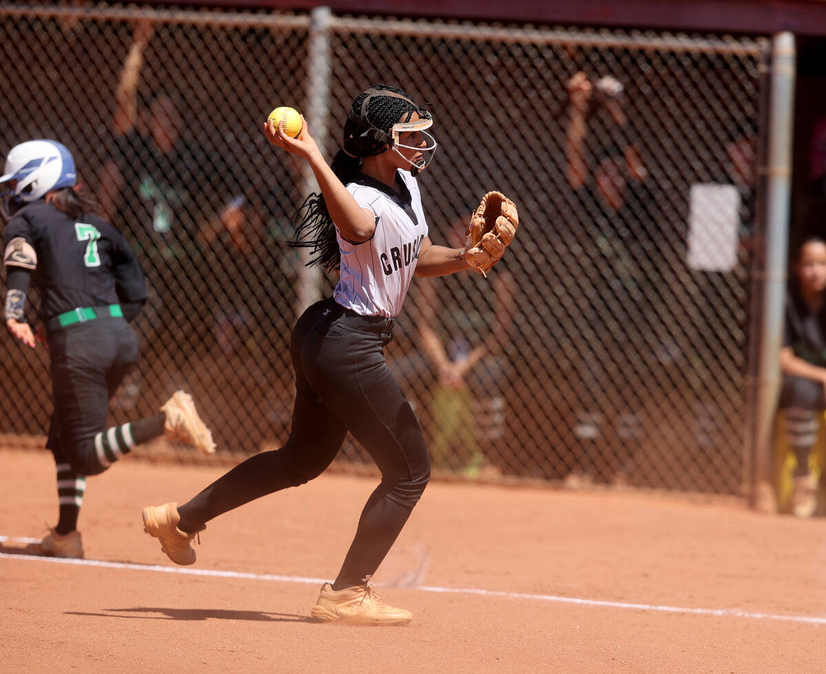 Faith Lutheran Ava Walker (2) throws to home for an out against Green Valley in the 2nd inning ...