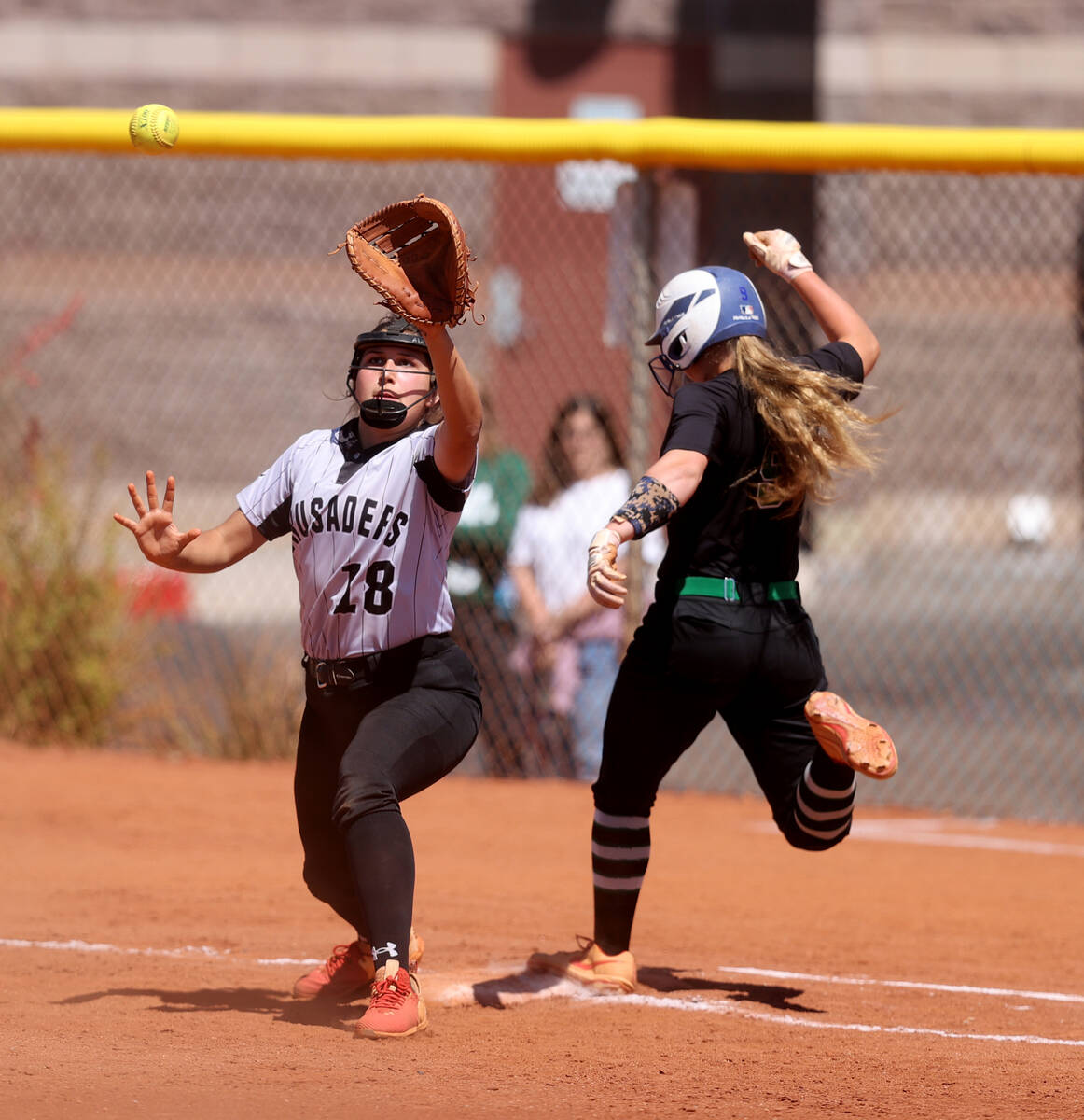 Green Valley’s Aspyn Beattie (9) is safe at first base as Faith Lutheran’s Ava Ma ...