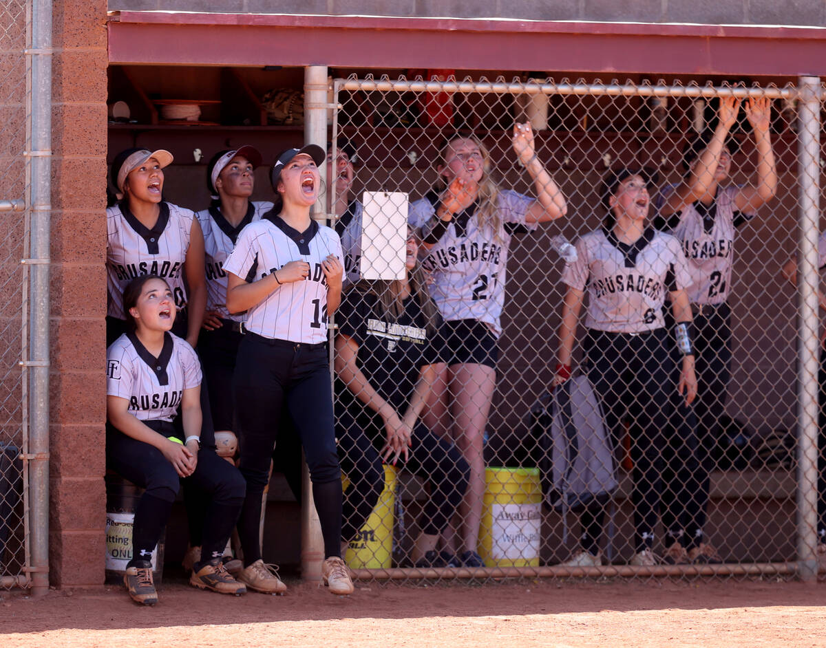 Faith Lutheran players watch a Green Valley fly ball fall into the gap that scored a run for th ...