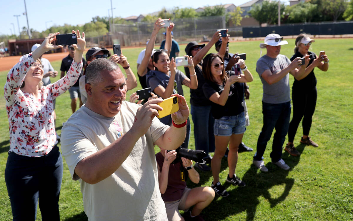 Parents and friends of Faith Lutheran players take photos after their team beat Green Valley in ...