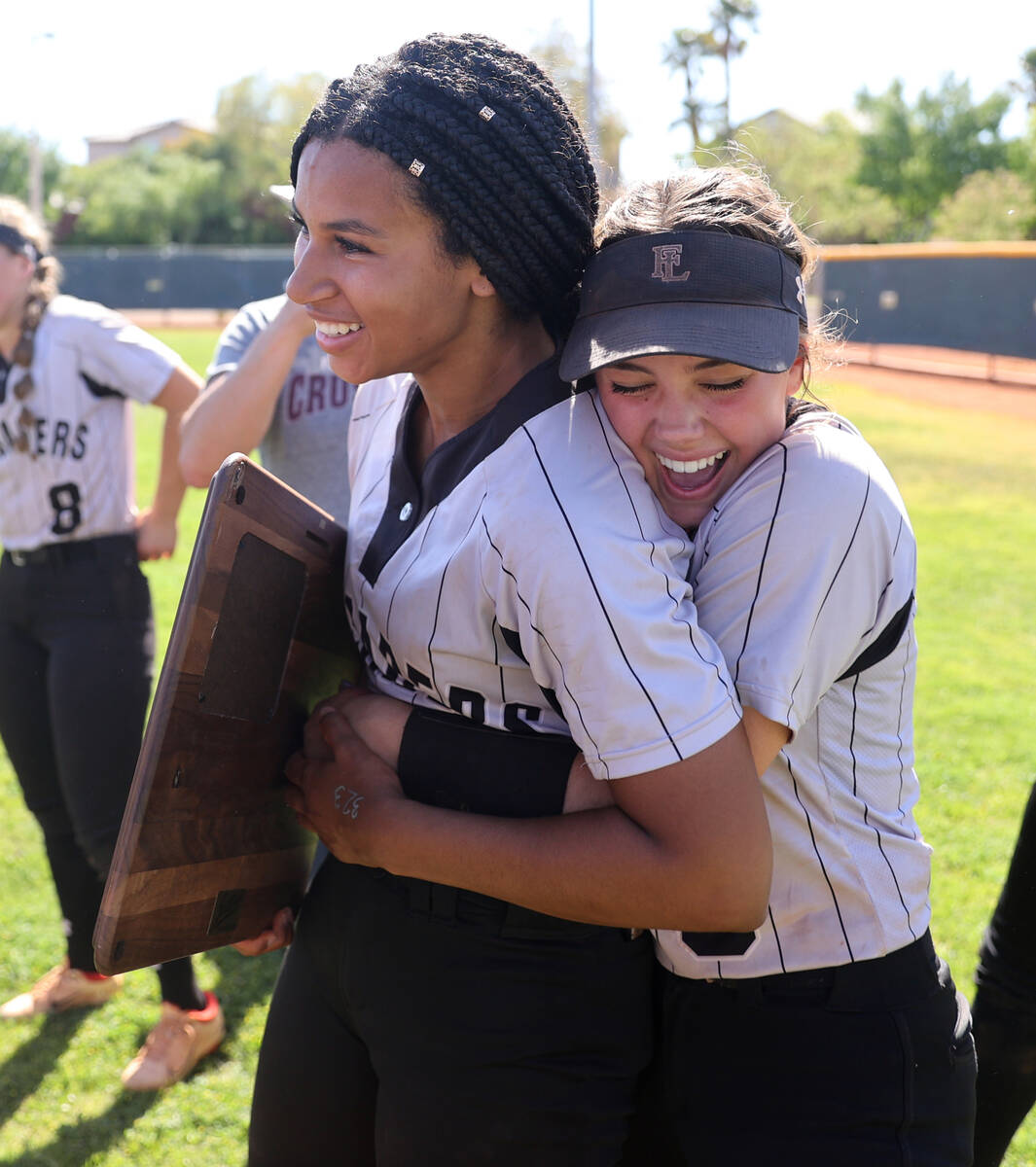 Green Valley players, including Faith Lutheran Ava Walker (2), left, and Emily Sholeff, celebra ...