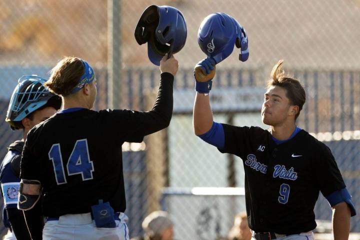 Sierra Vista’s J.T. Starkus (9) celebrates with teammate Mikey Clark (14) after hitting a hom ...