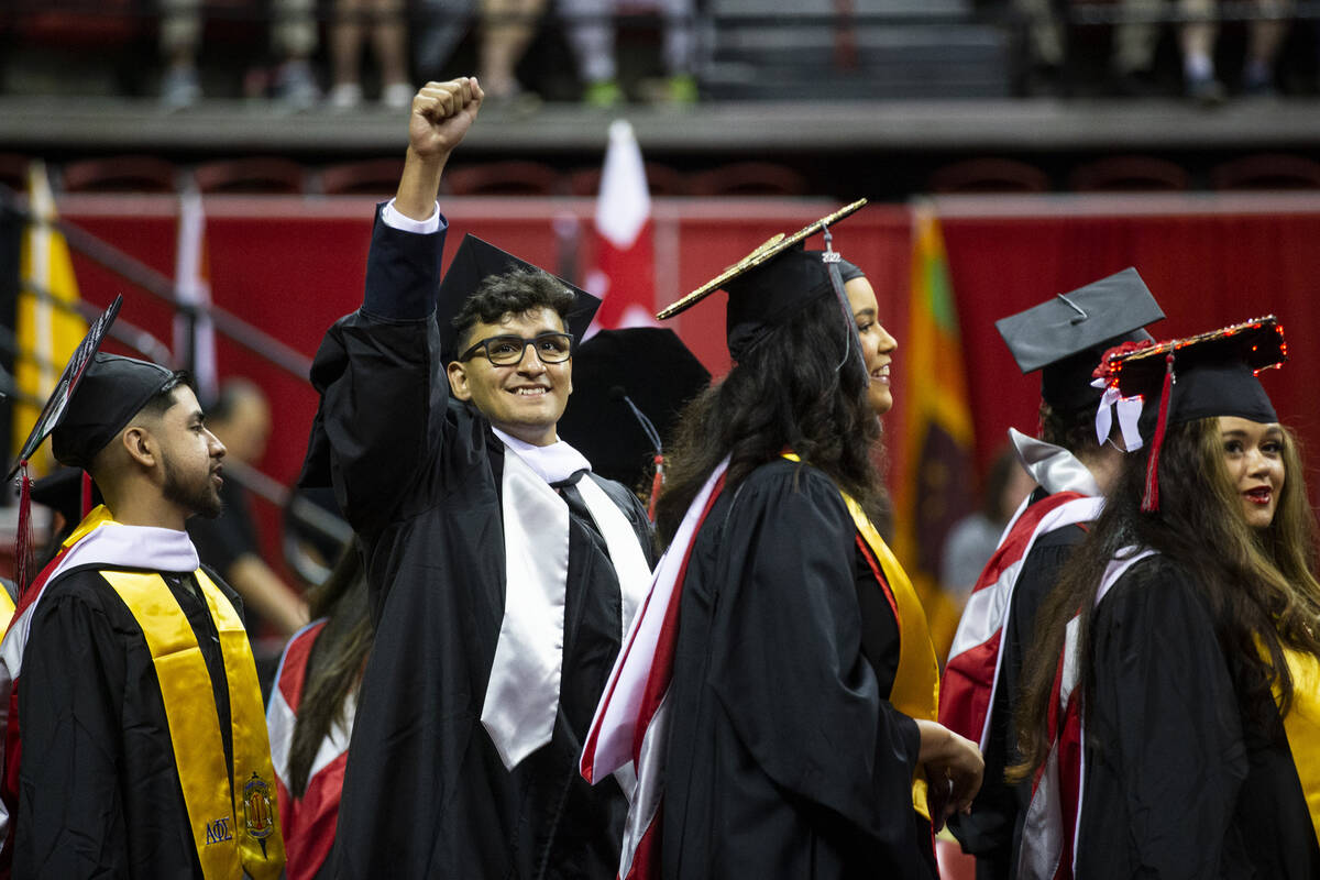 Postgraduate German Martinez raises his fist during an UNLV commencement ceremony at the Thomas ...