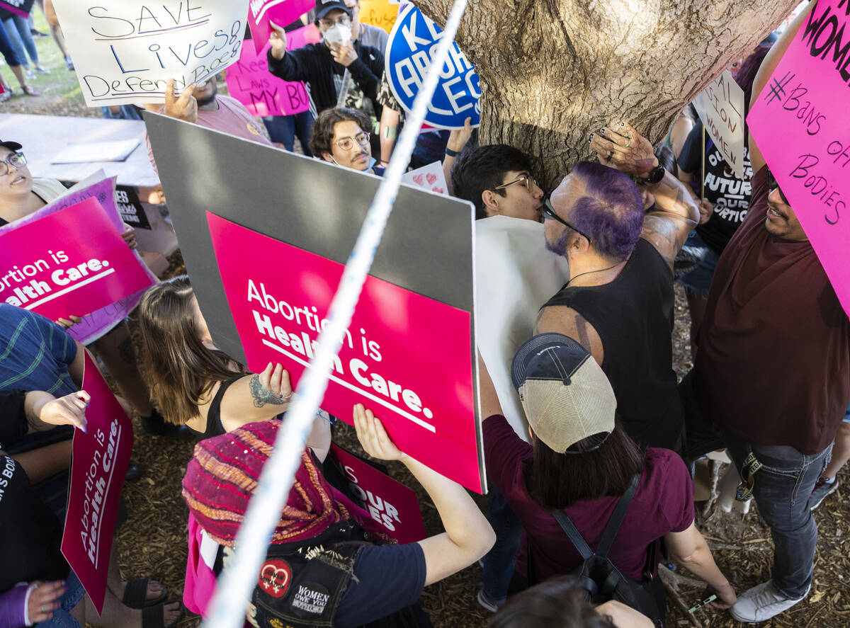 Demonstrators clash with an anti-abortion activist, middle, protest during a pro-abortion rally ...